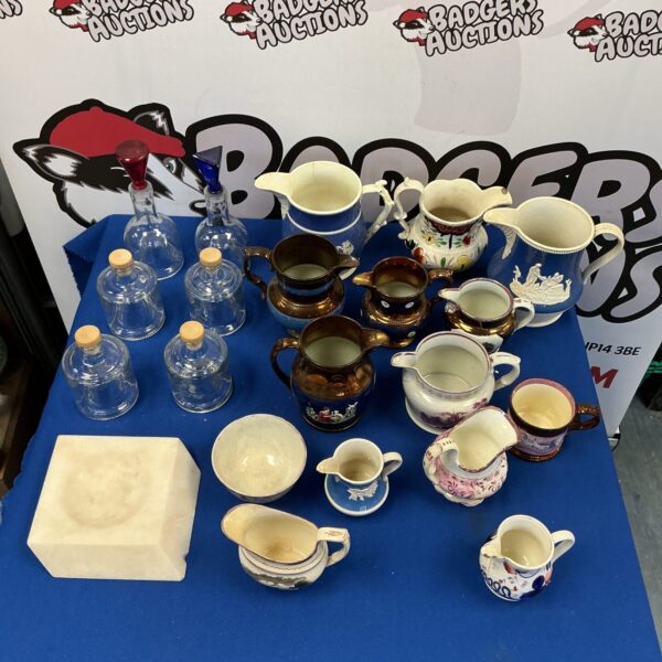 Vintage collection of jugs and bottles displayed for sale.