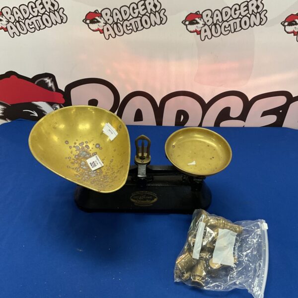 Vintage kitchen scales with brass weights for accurate measurement.