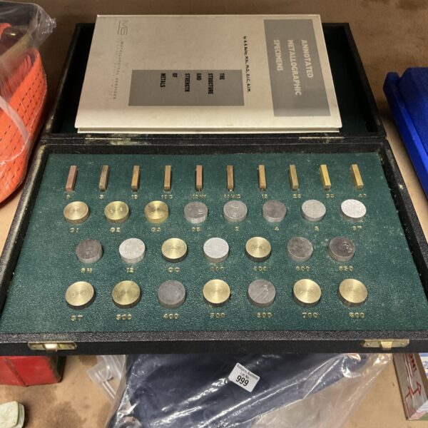 Vintage metallographic specimen set with annotated metal samples.
