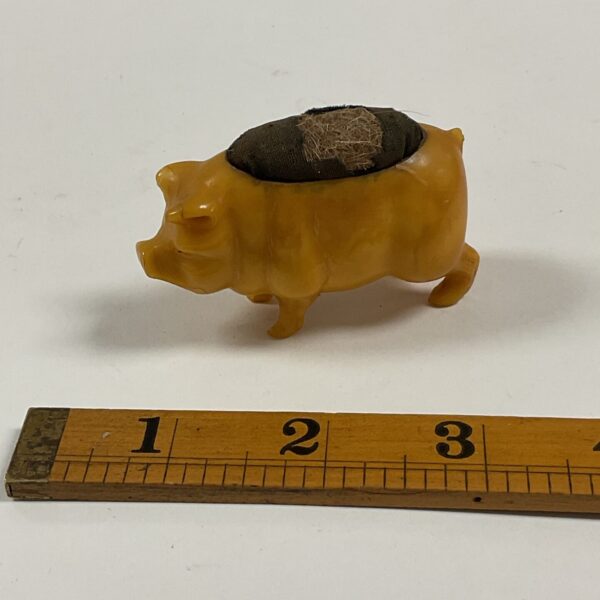 Vintage pink plastic pig pin cushion for sewing.