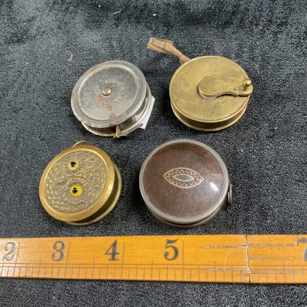 Lot of four vintage pocket tape measures with brass casings.
