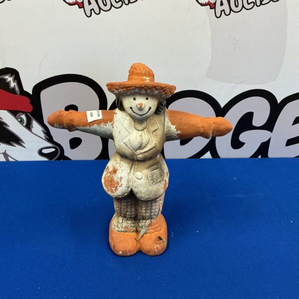 Vintage cast iron scarecrow door stop for farmhouse decor.