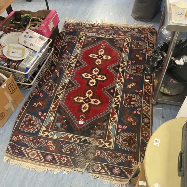 Detailed view of a vintage woven rug with intricate patterns.