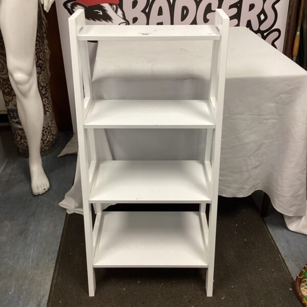 White wooden shelving unit with three tiers for display.