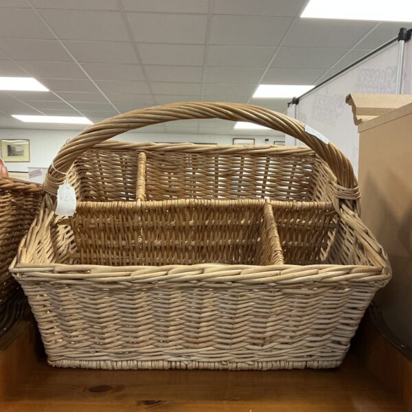 Multi-compartment wicker basket for storage and display.