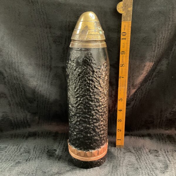 WWI inert cannon shell with brass fuse, antique military collectible.