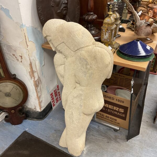 1930s abstract stone sculpture of embracing lovers.