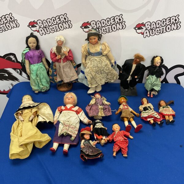 Antique folk art doll with painted face and period clothing.
