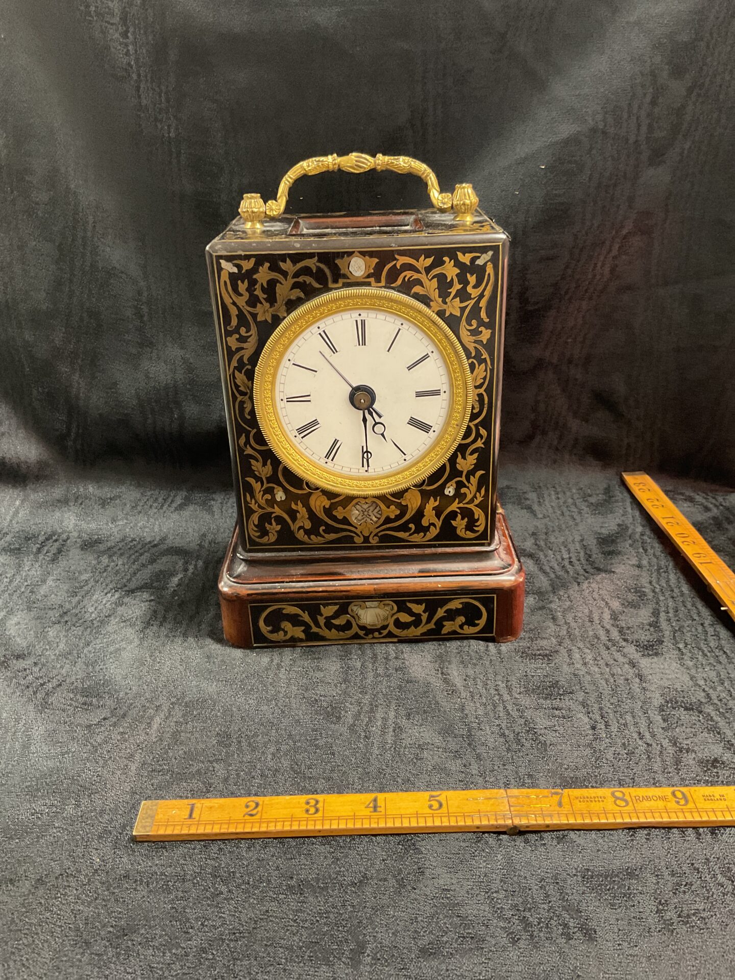 897 Antique French Capucine or officers travel clock with brass inlay features brass fusee movement with bell for striking the hours and quarters missing glass face