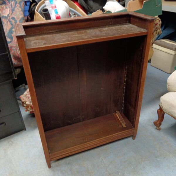 Antique mahogany bookcase awaiting restoration, classic Victorian shelving.