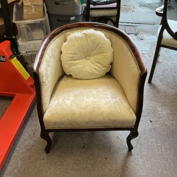 Ornate antique solid wood chair with patterned upholstery.