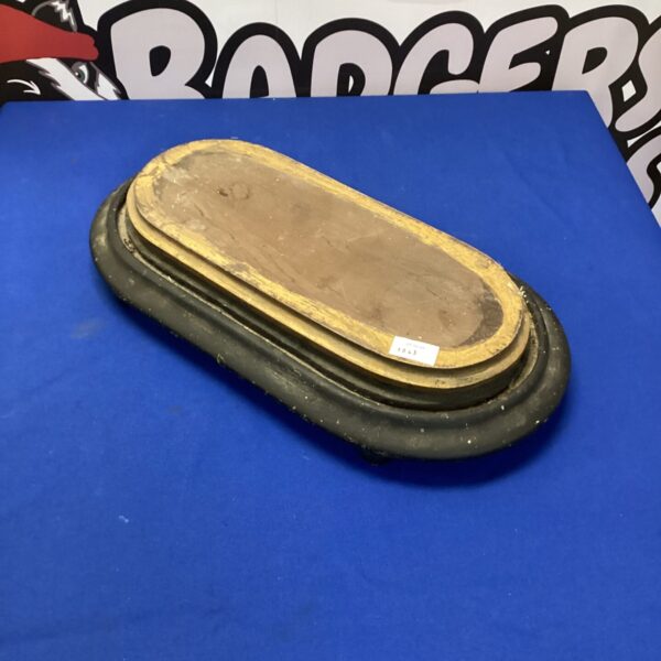 Antique wooden display stand with a circular top and curved feet.