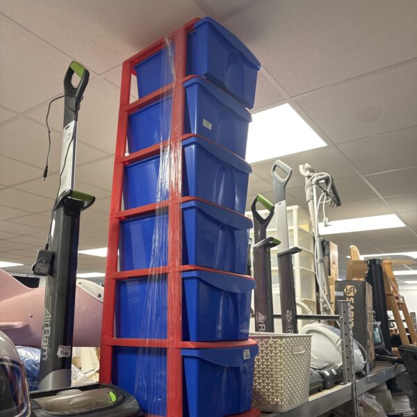 Stack of six blue plastic storage drawers for home organisation.