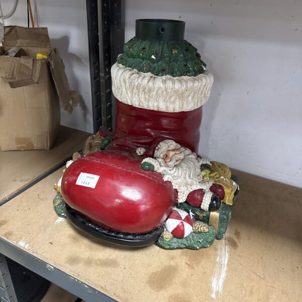 Festive resin Christmas tree stand boot for holiday decorations.
