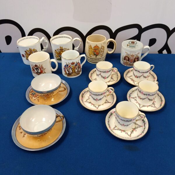 Group of vintage commemorative china mugs and teacups.