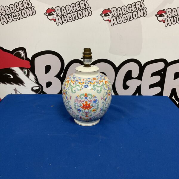 Vintage ceramic table lamp with floral design.