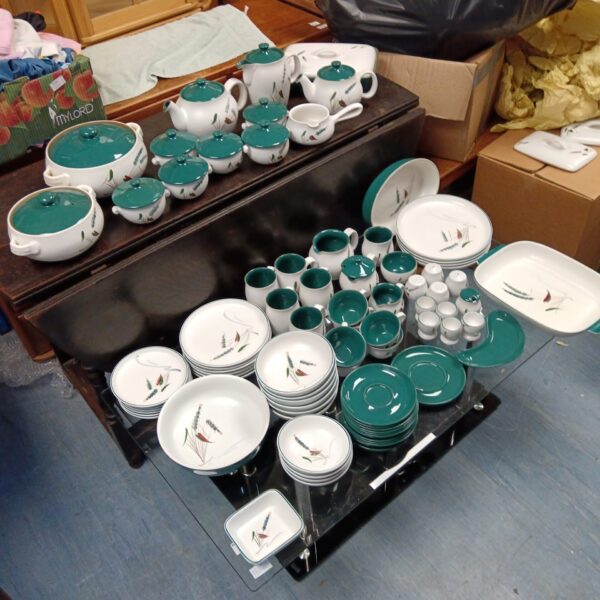 Large Denby Wheat Sheath dinner service set on a table.