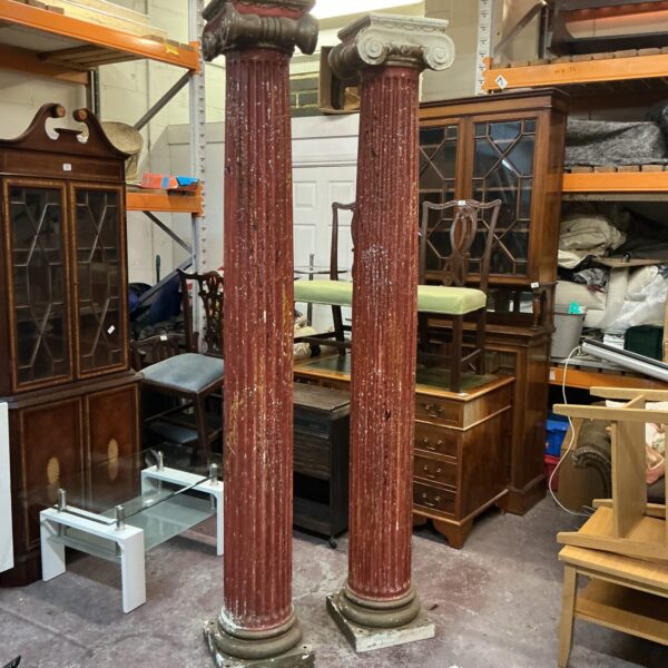 Two weathered fibre glass Greek columns for garden or patio decor.
