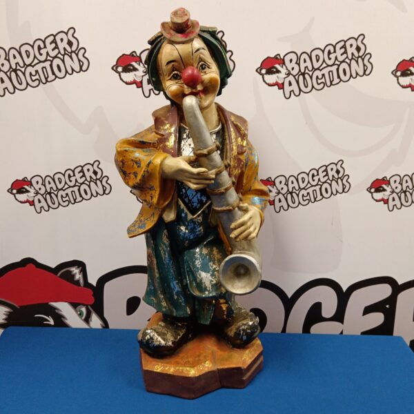 Large vintage fibreglass clown statue playing a saxophone.