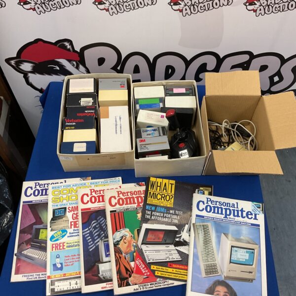 Vintage floppy disks and computer books collection for retro computing enthusiasts.