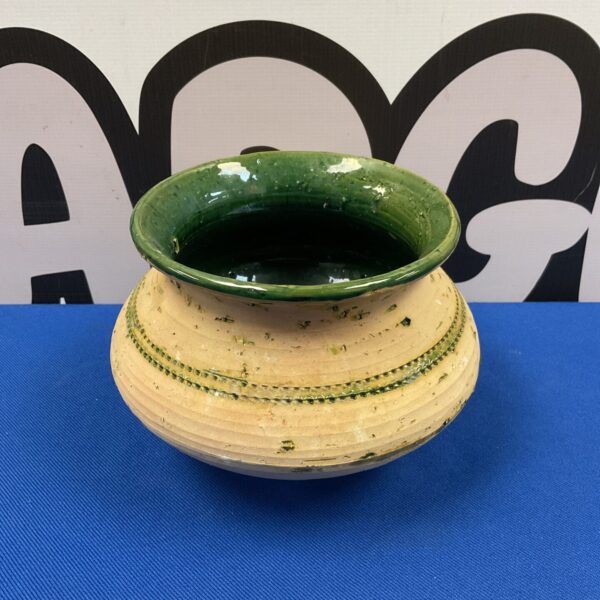 Vintage green glazed studio pottery vase with speckled texture.