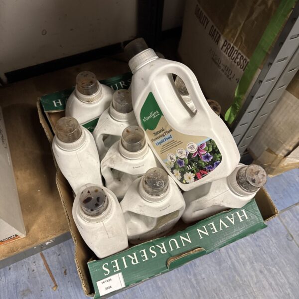Assorted Mamaterra plant food bottles for garden care.
