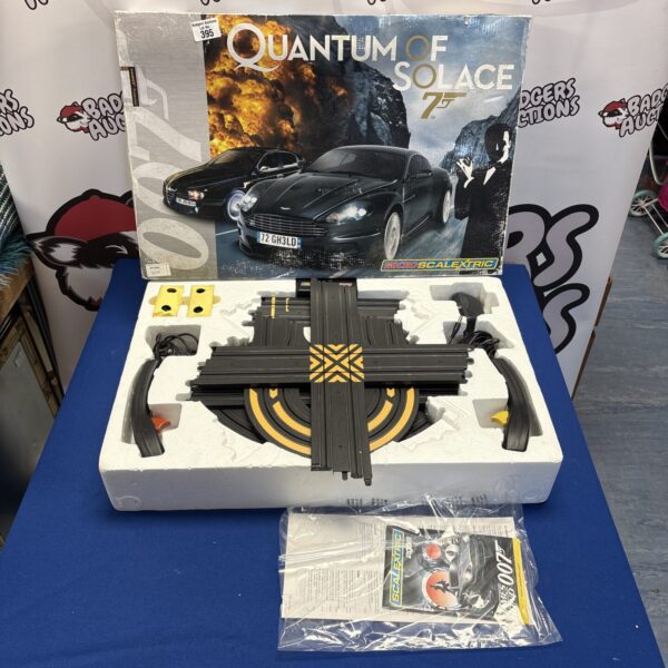 MicroScalextric Quantum Of Solace track set with vehicles and track pieces.