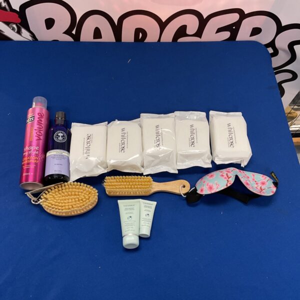 Mixed beauty and grooming lot with hairspray and skincare.