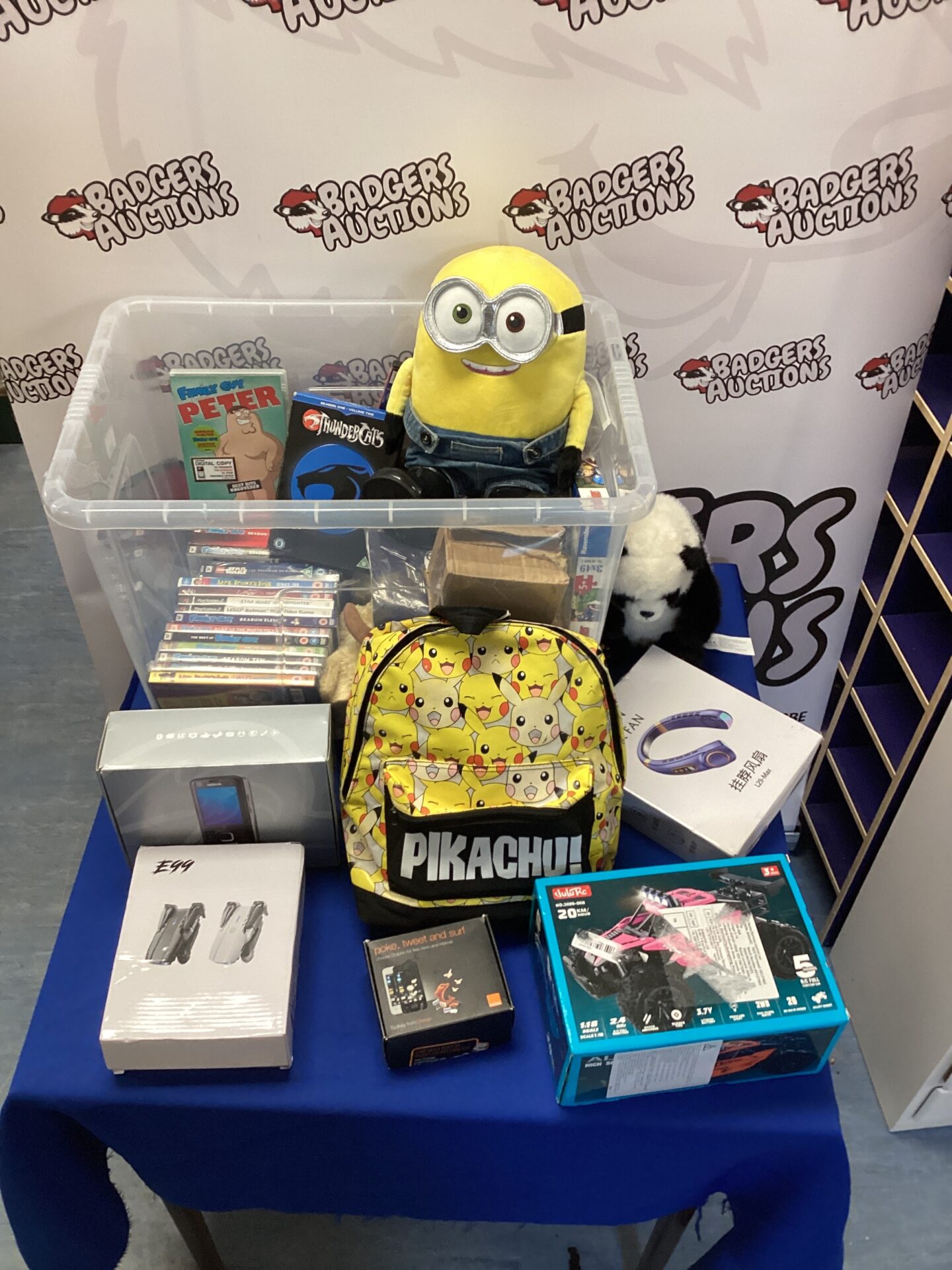 102 Large box of mixed including Family Guy DVDs, Nokia mobile phone Pikachu rucksack and RC buggy