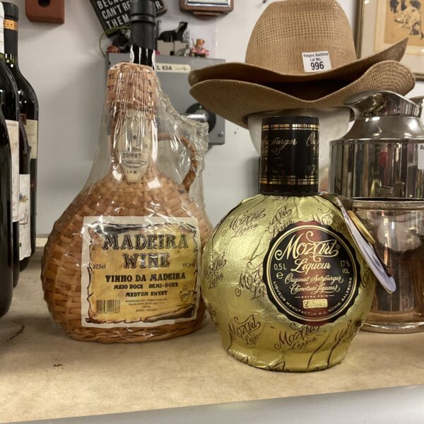 Vintage sealed bottles of Mozart chocolate liqueur and Madeira wine.