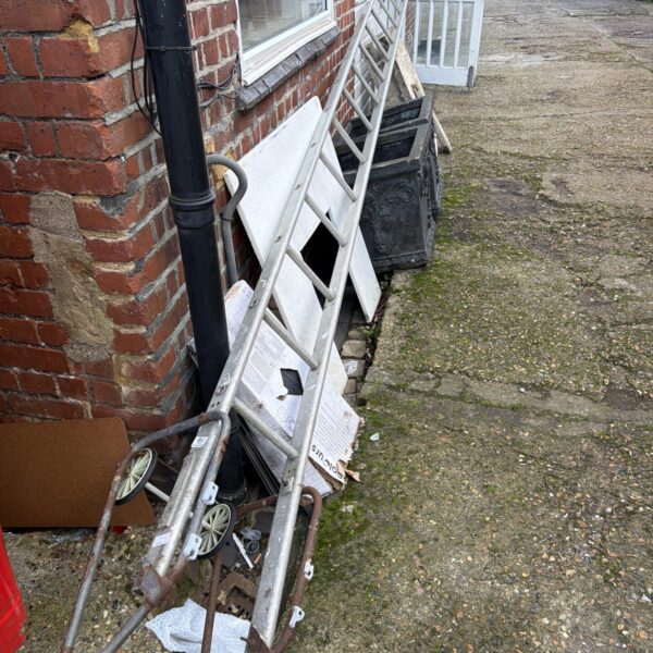 Aluminium extension roof ladder leaning against a wall.