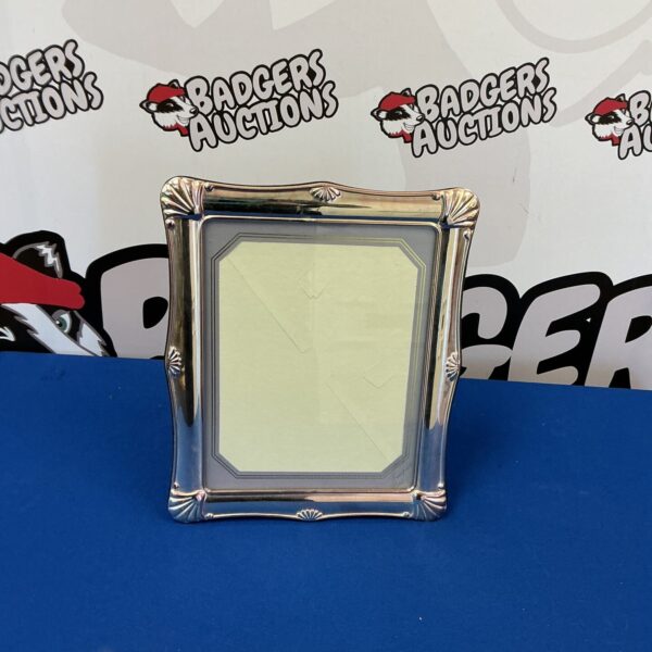 Ornate silverplate photo frame for 12x10 inch photos.