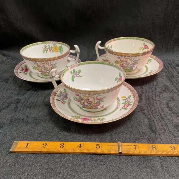 Antique Spode Copeland tea cups with floral pattern on saucers.