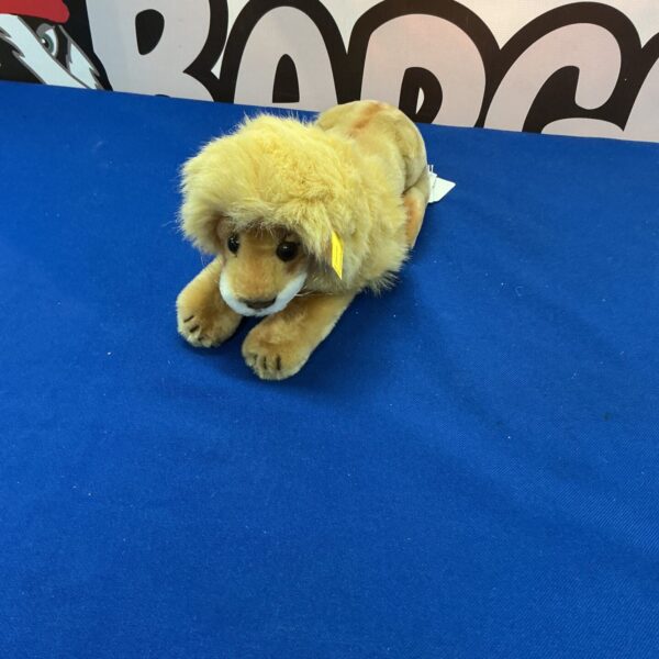 Vintage Steiff lion plush toy, golden and collectible.