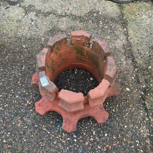 Vintage terracotta chimney pot with nine-point crown design for garden decor.