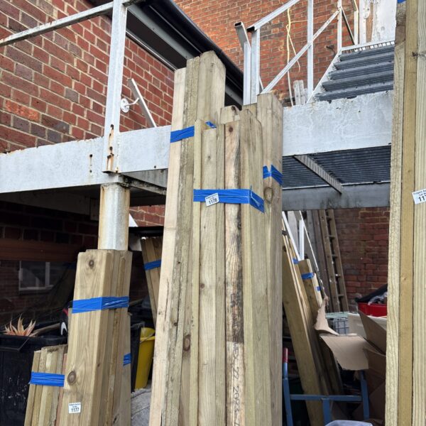Three bundles of 7ft timber stacked outdoors, ready for construction.