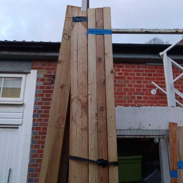 Stack of three timber bundles secured with strapping.