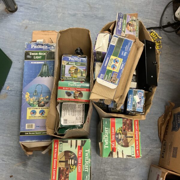Multiple boxes of Twilight range low voltage garden lights for outdoor use.