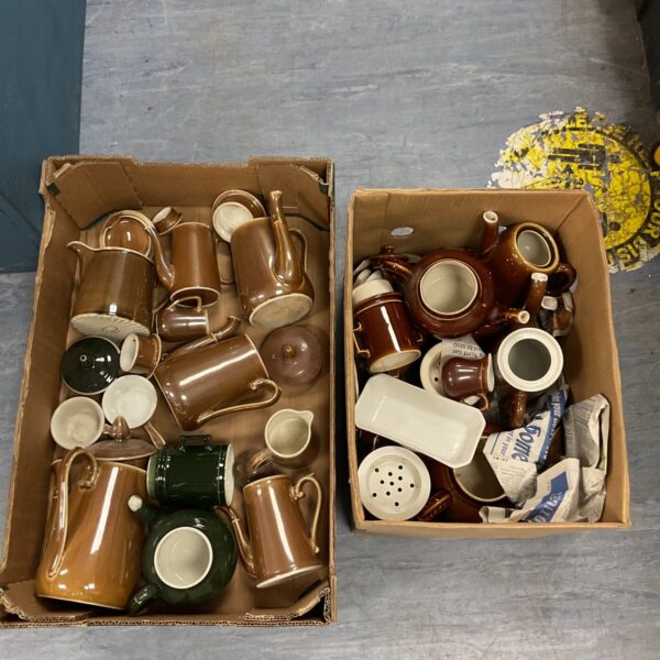 Vintage ceramic coffee and tea pots in a cardboard box.