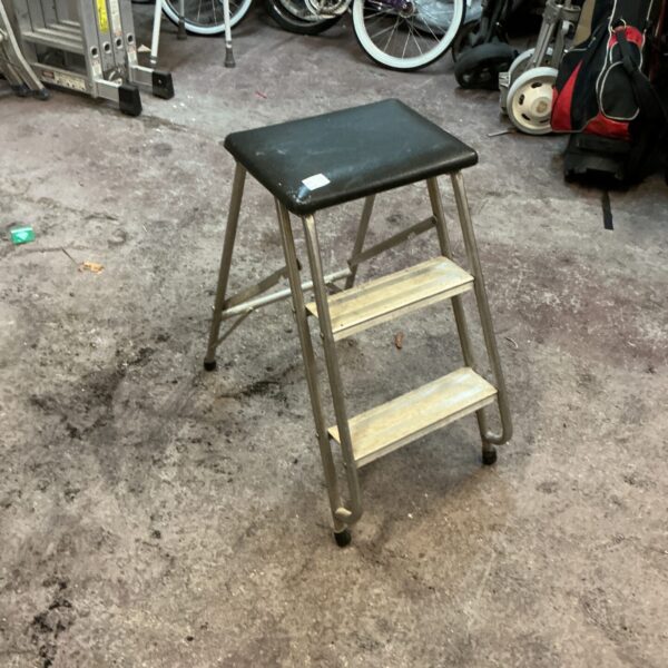 Vintage folding kitchen steps in a domestic setting.