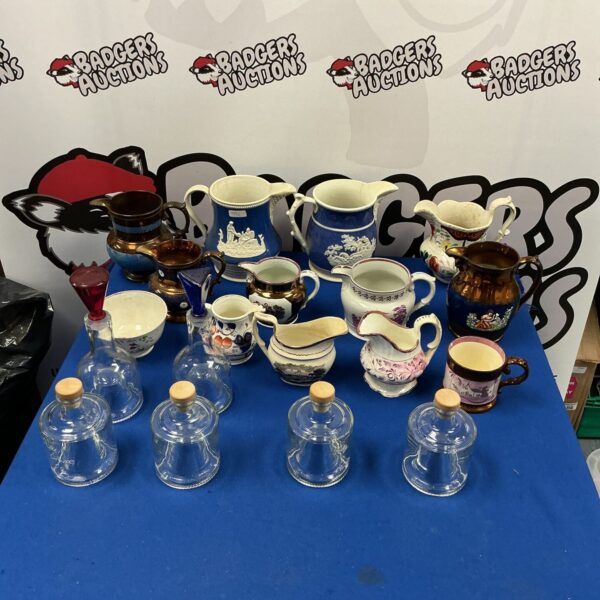 Collection of vintage jugs and jars on a table.