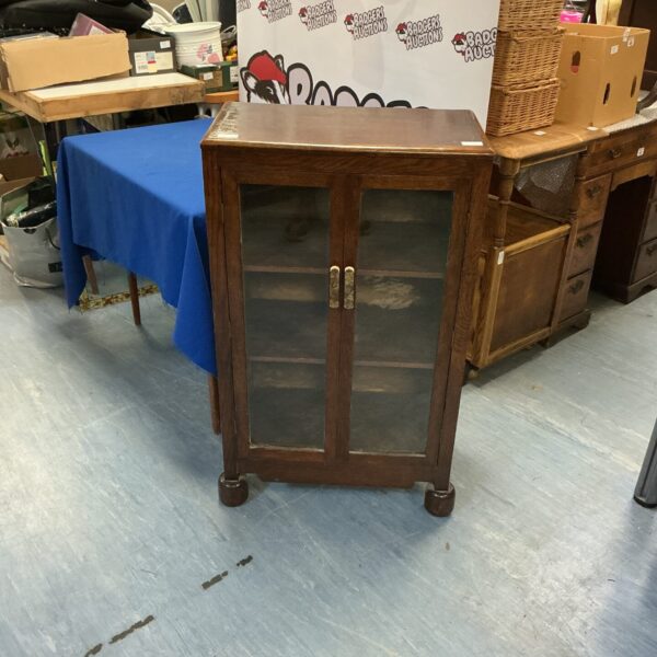 Vintage mahogany two-door cabinet for display and storage.