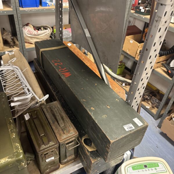 Two long vintage military wooden storage boxes with visible wear.