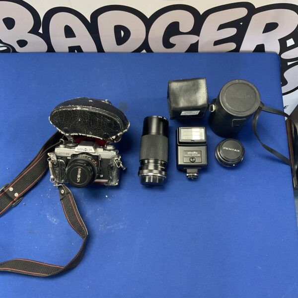 Vintage Minolta camera with lenses, a classic film photography system.