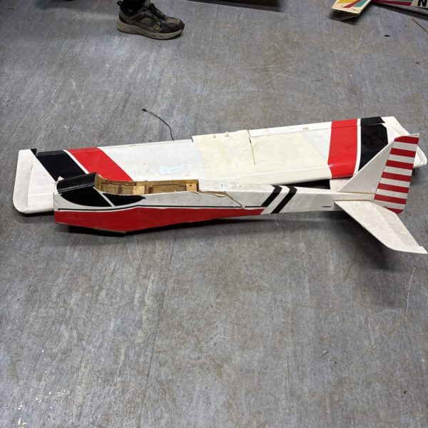 Side view of a vintage wooden model aeroplane for restoration.