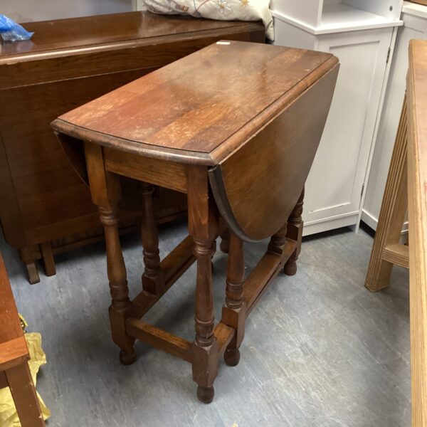 Vintage oak drop leaf table with turned legs.