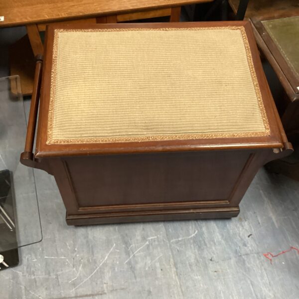 Vintage padded storage stool with brown finish and upholstered top.