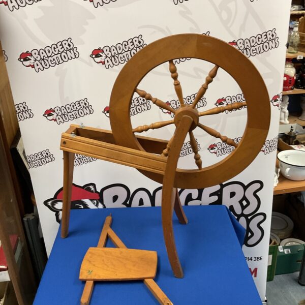 Vintage wooden spinning wheel, antique fibre arts tool.