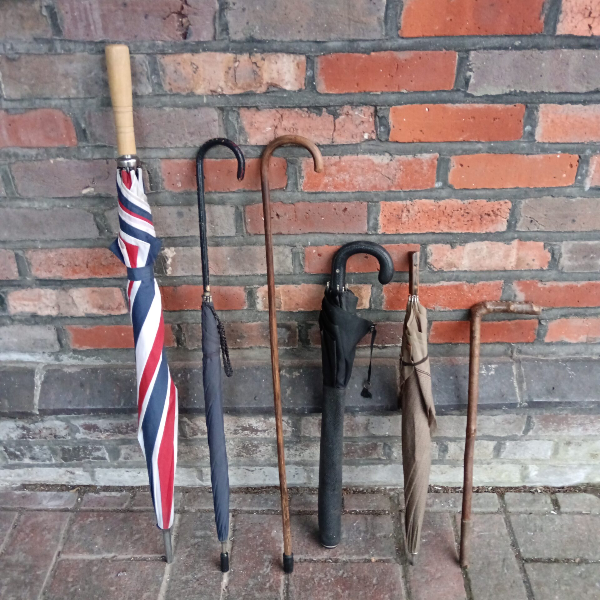 847 Bundle of umbrellas some vintage with walking cane & riding crop