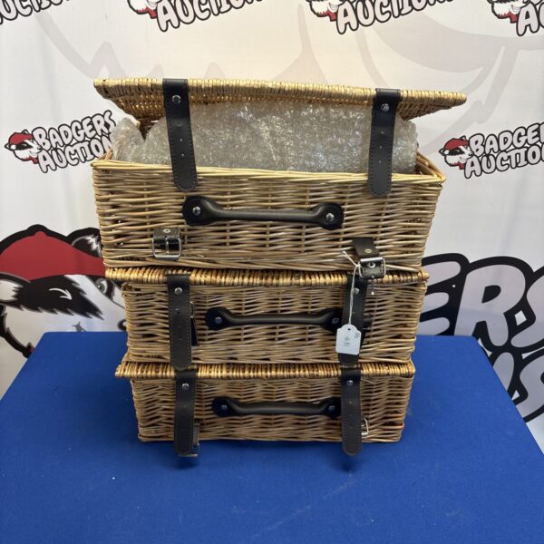 Lot of three woven wicker storage baskets for hampers and storage.